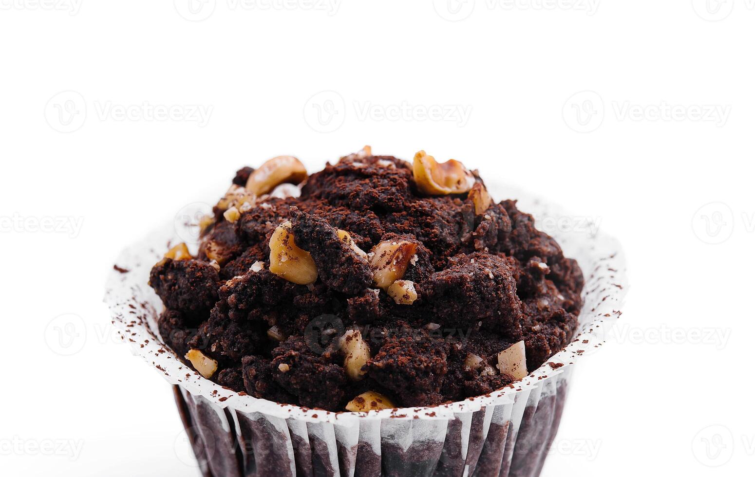 One black chocolate muffins with nuts crumbs isolated photo