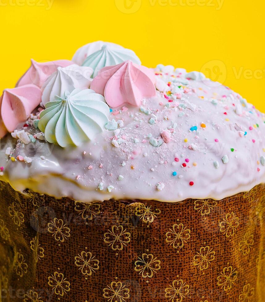 Traditional Easter cakes with meringue on yellow background photo