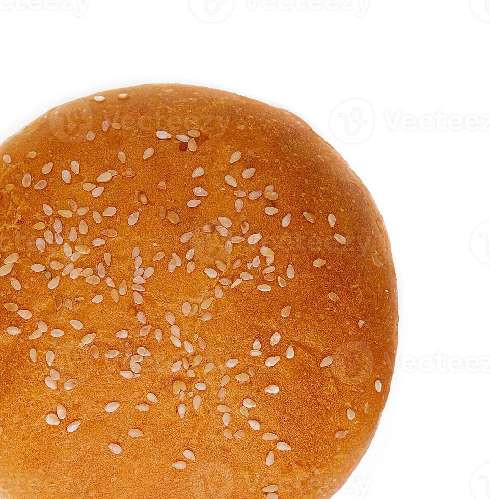 Fresh burger bun with sesame seeds isolated on top view photo