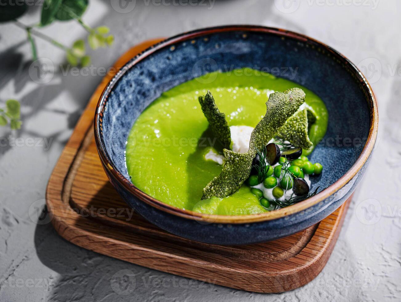 peas, broccoli, spinach cream soup in a bowl photo