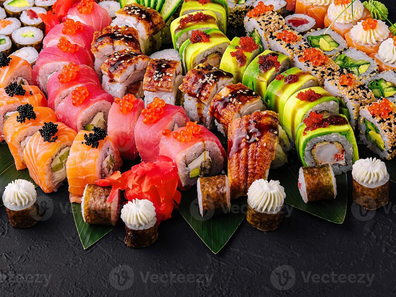 Large sushi set, shot from the top on a black background photo