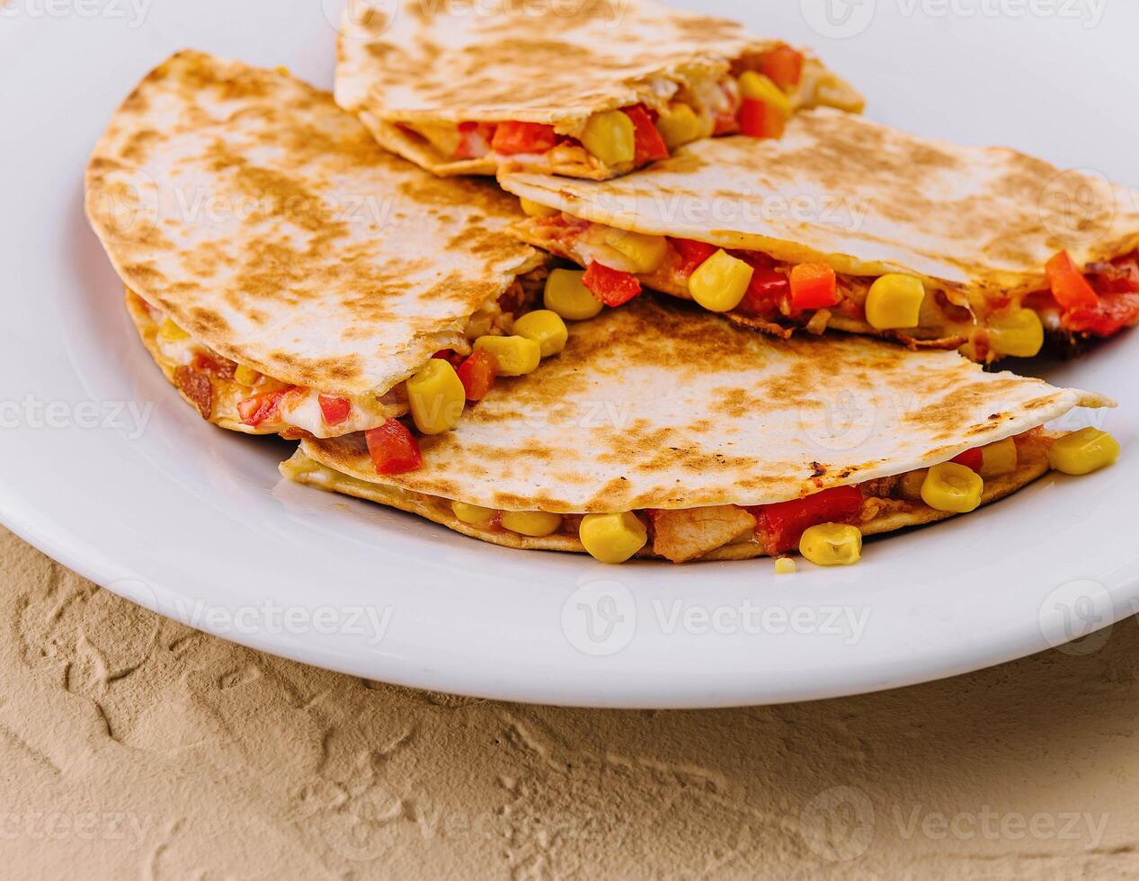 Mexican quesadilla with vegetables on plate photo