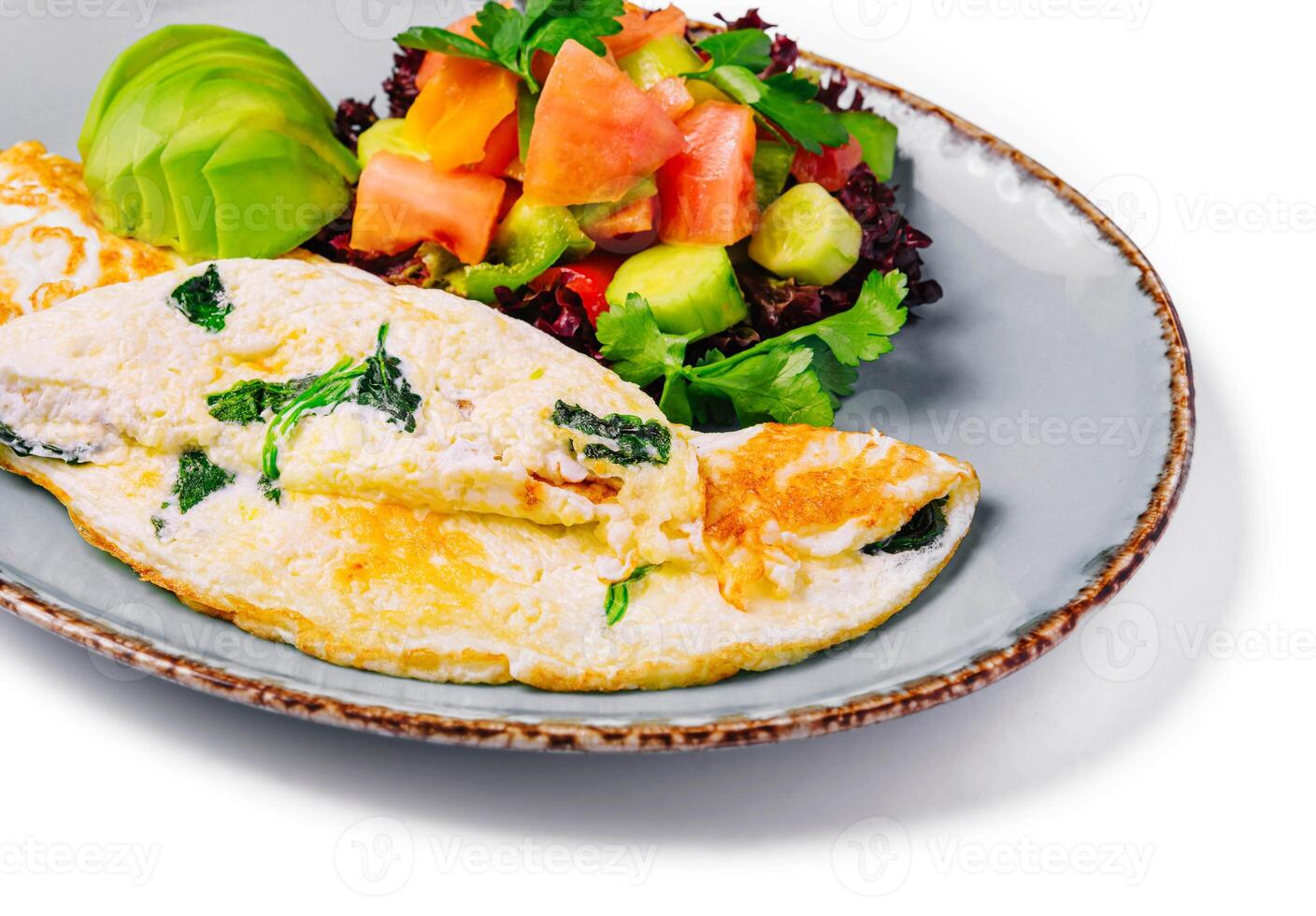 Omelette stuffed with vegetables on plate photo