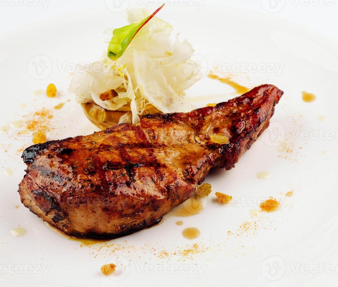 Grilled pork steak with salad leaves photo