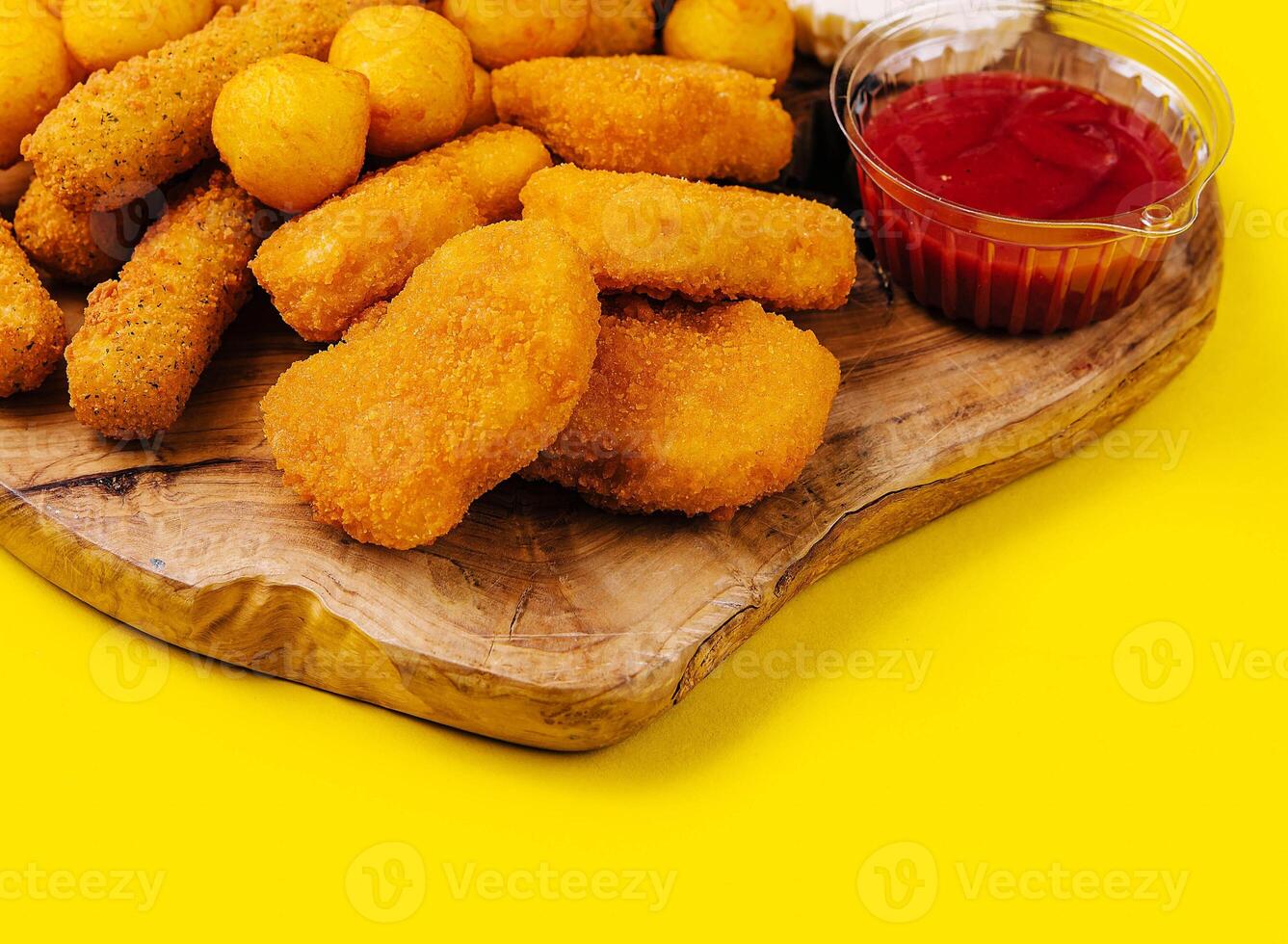 nuggets and cheese balls with sauces photo