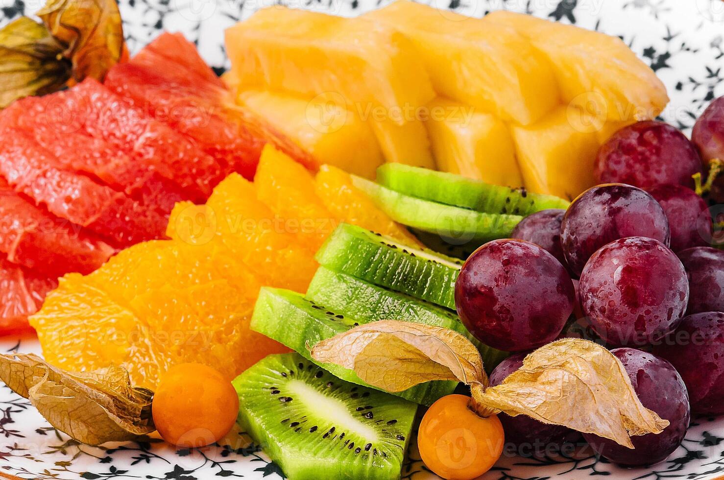 kiwi smoothie with different tropical fruits on a plate photo