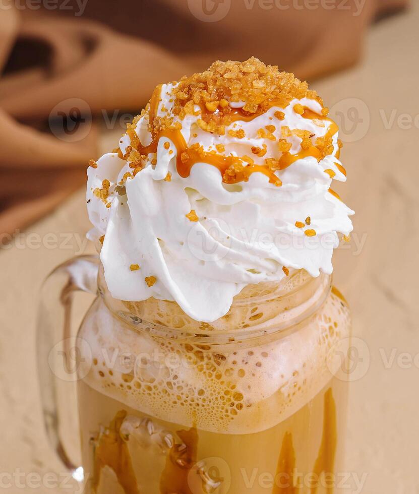 Caramel iced latte with whipped cream and syrup photo