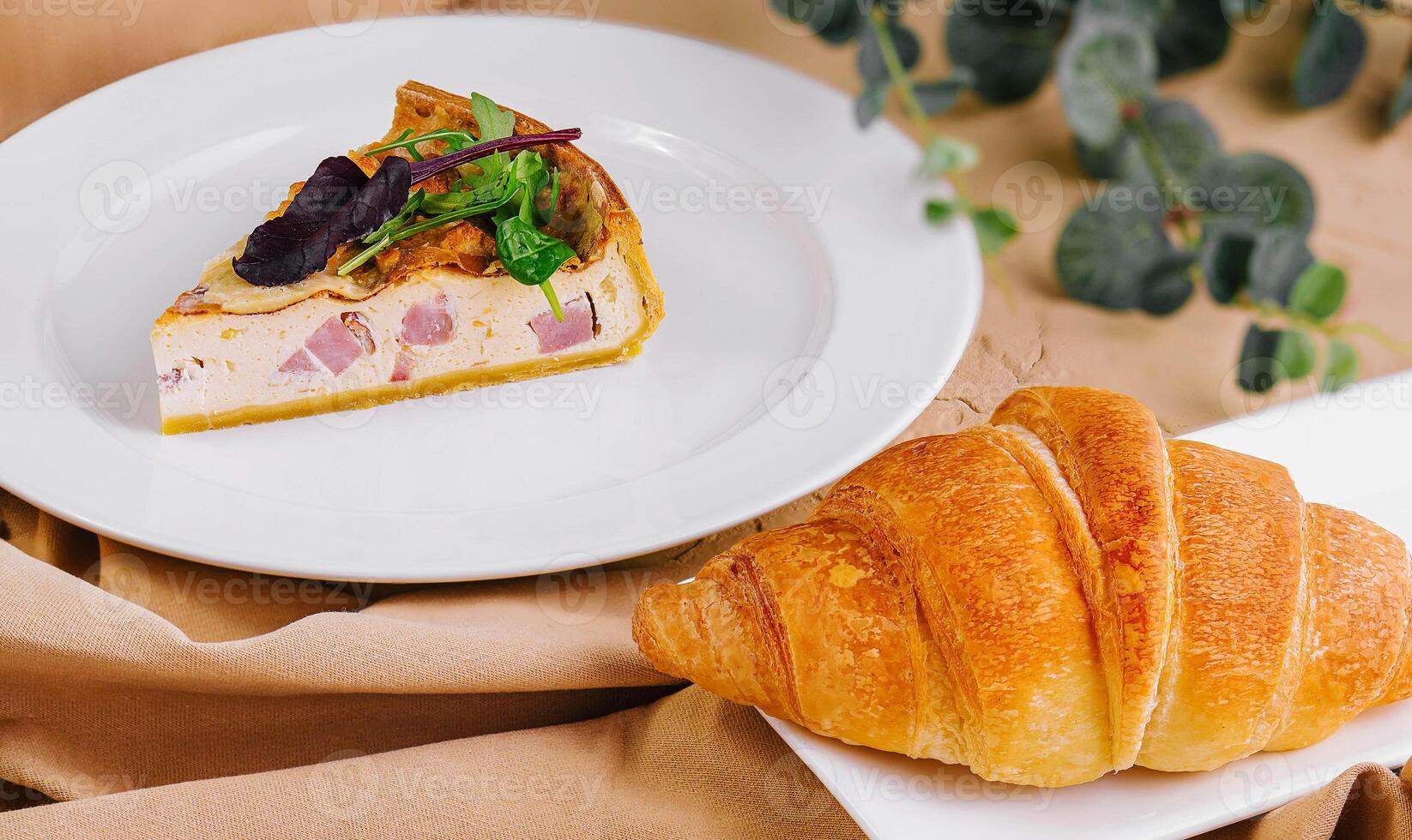Quiche Lorraine and croissant on White Plates photo