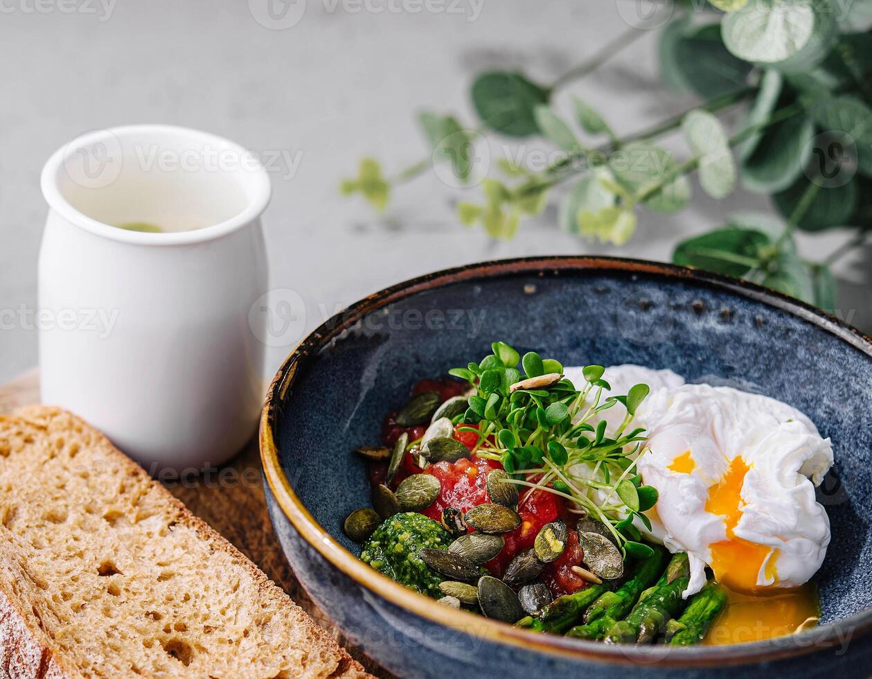 Salad of asparagus, tomatoes and poached egg photo