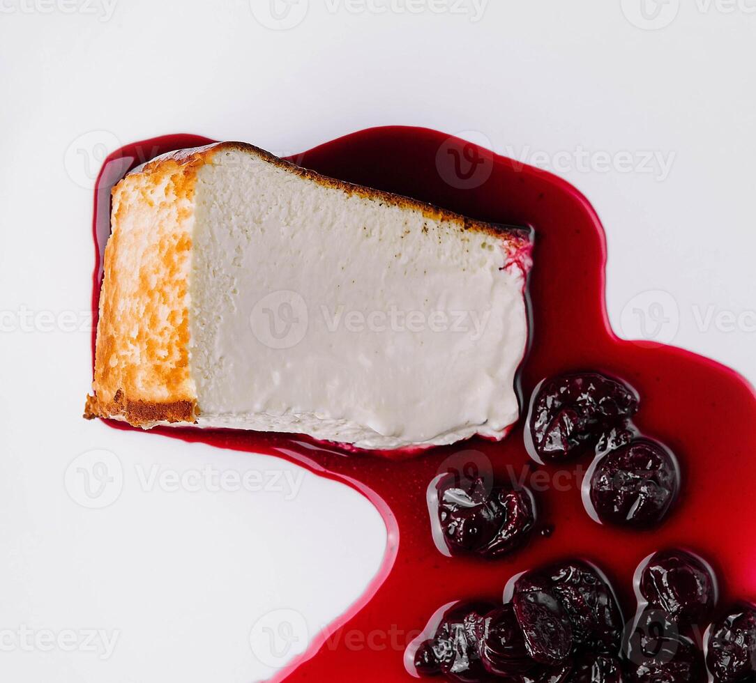 Cheesecake with berry sauce on plate photo