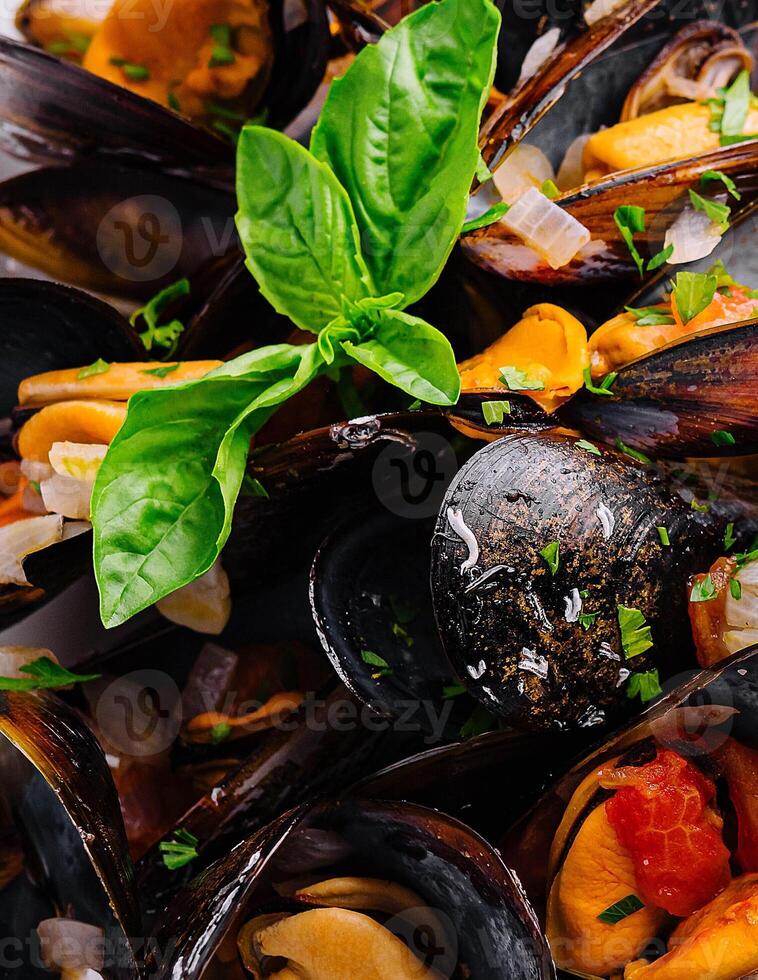 Delicious seafood mussels with sauce and parsley photo