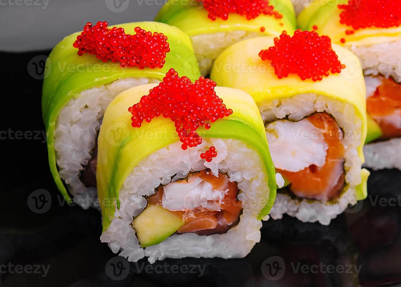 sushi rolls wrapped with avocado and shrimp inside photo