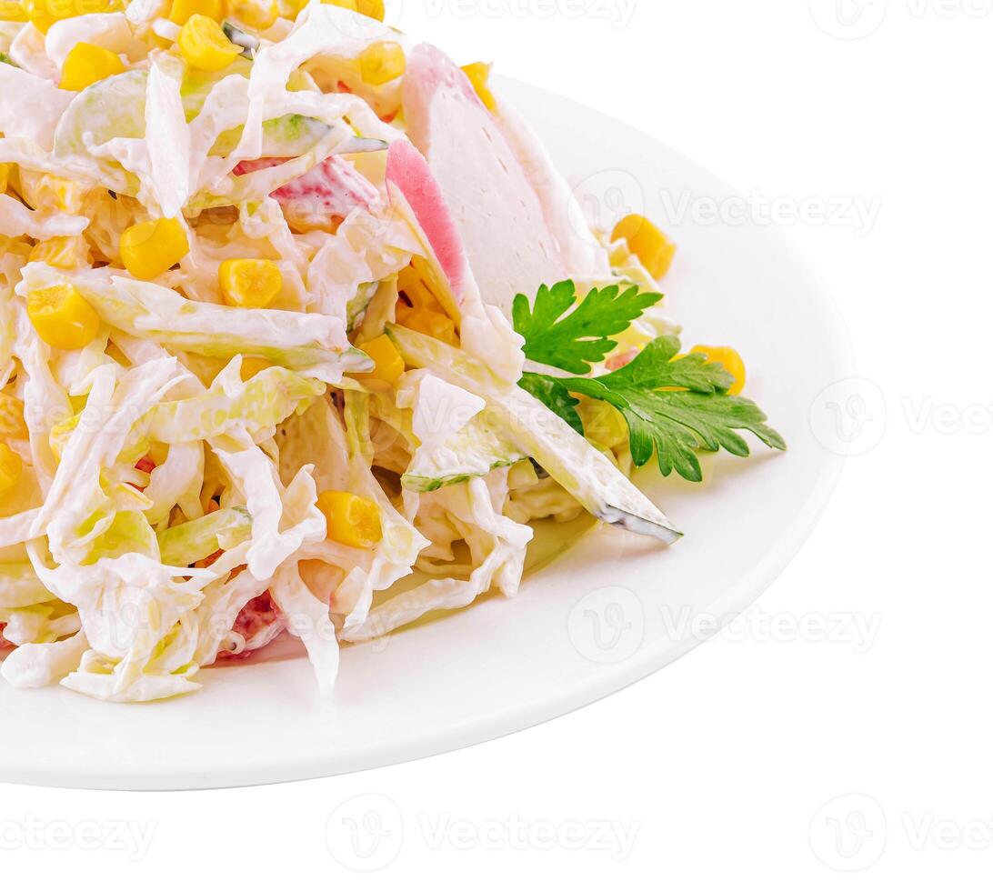 Salad with corn, crab sticks, cucumbers, eggs and mayonnaise photo