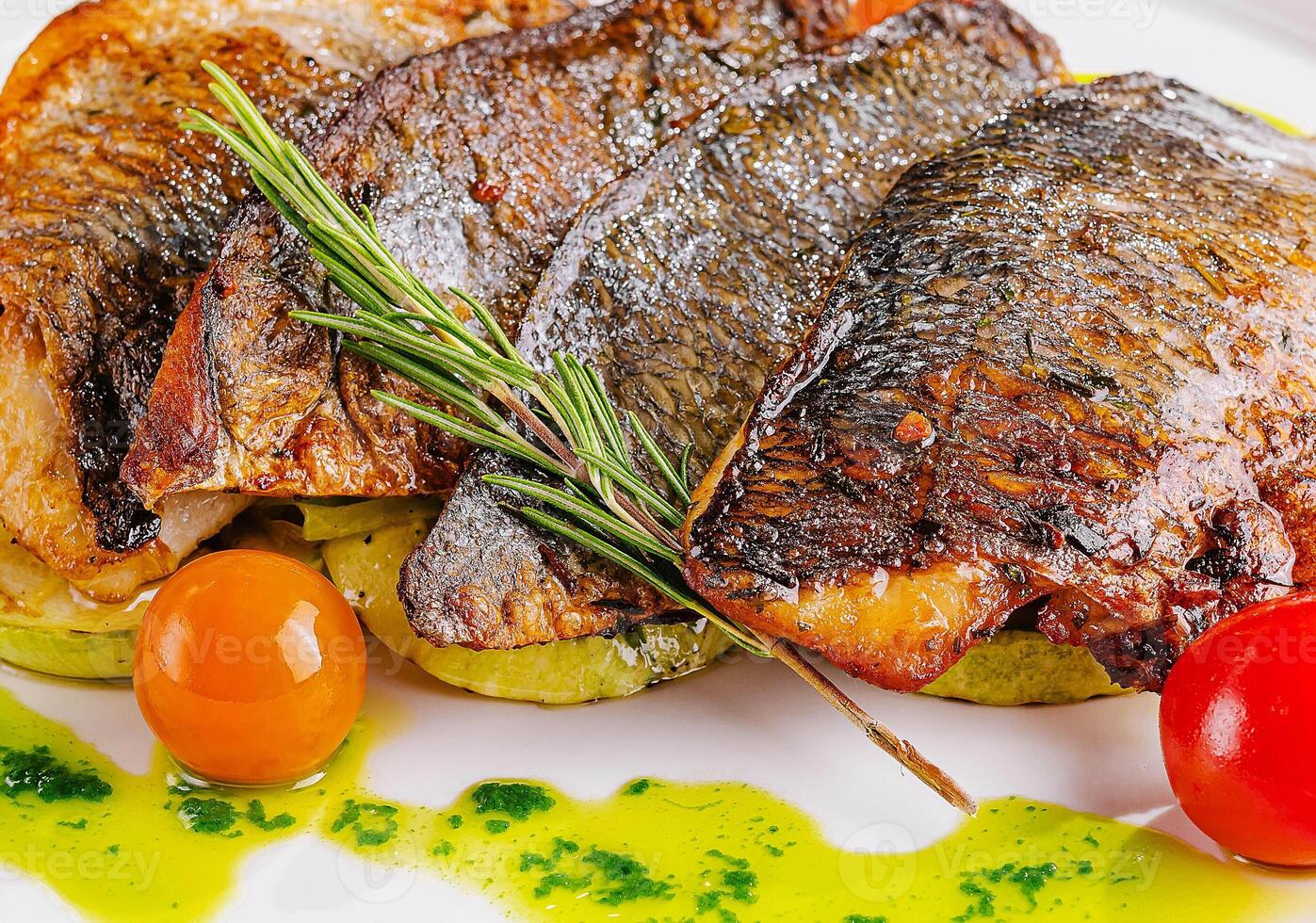 fried fish with vegetables on plate photo