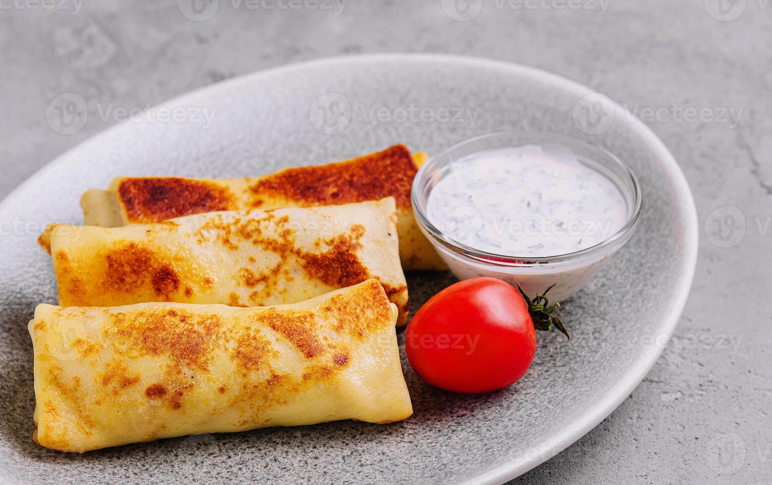 thin pancakes on plate top view photo