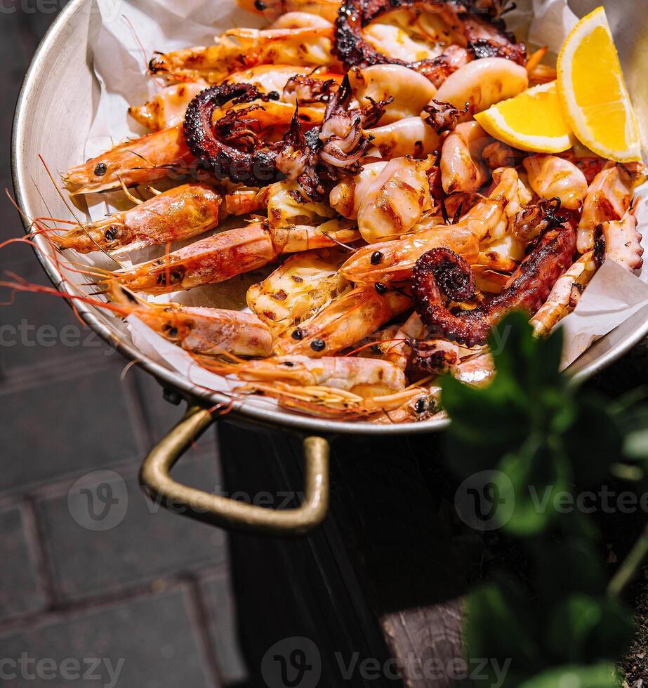 Grilled seafood plate with lemon photo