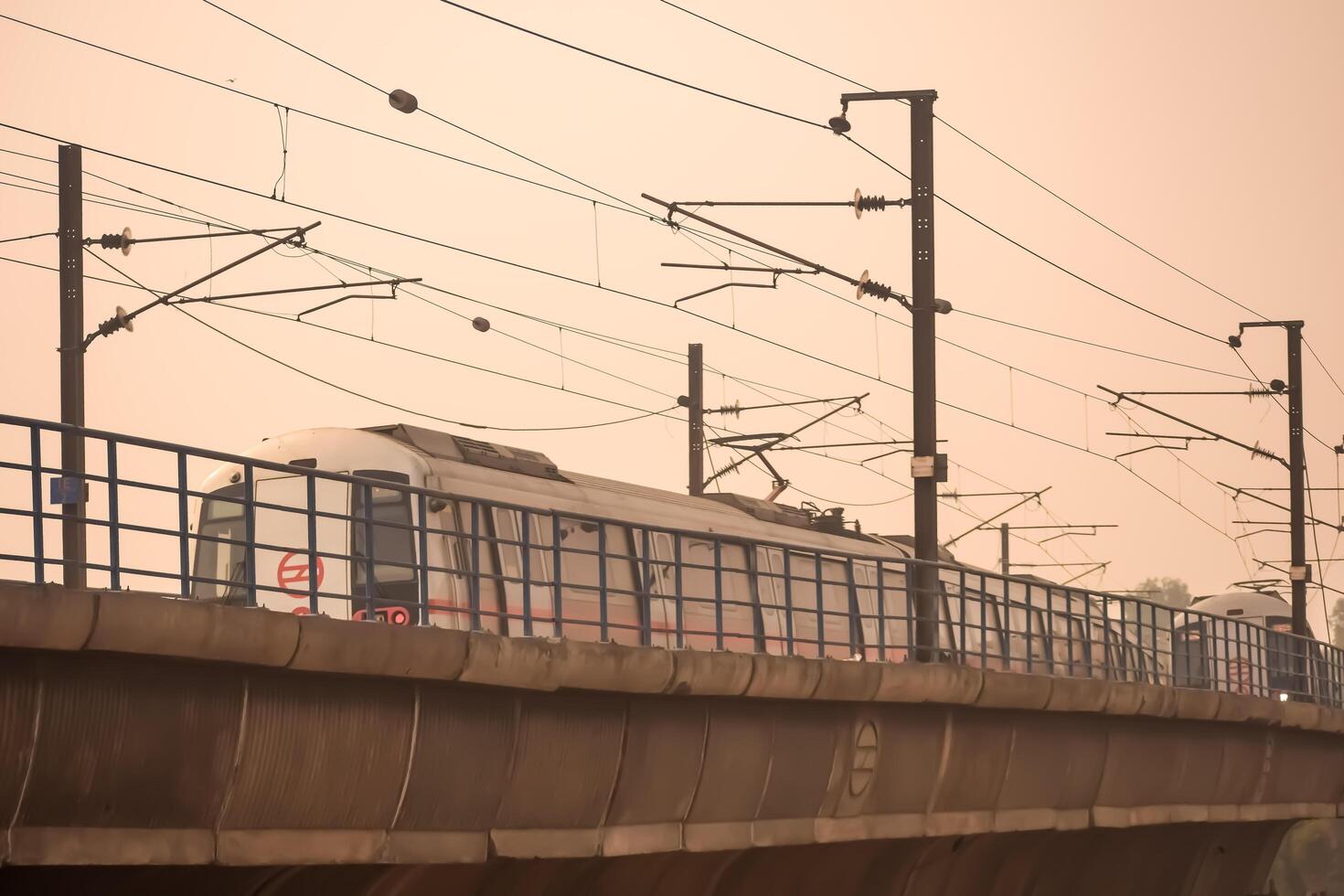 New Delhi, India, February 17 2024 - Delhi Metro train arriving at Jhandewalan metro station in New Delhi, India, Asia, Public Metro departing from Jhandewalan station photo