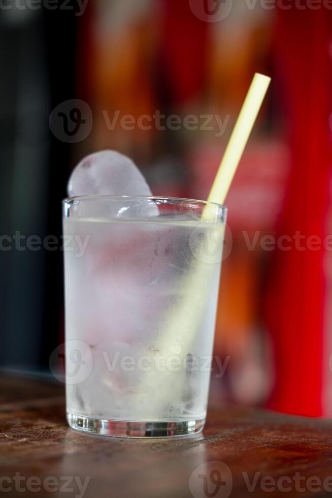 Water glass with ice in the glass on the table photo