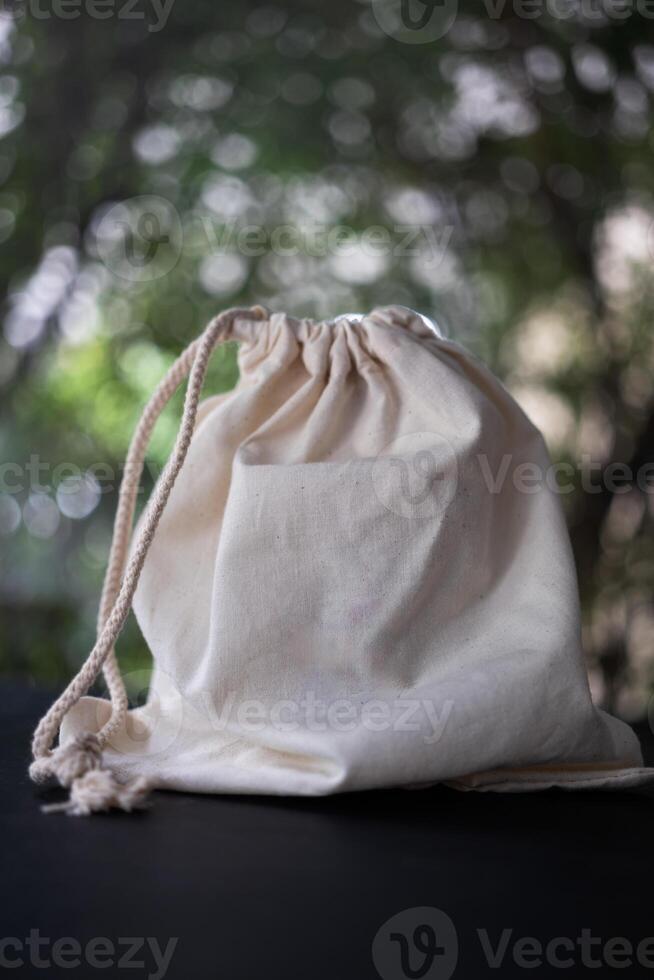 Canvas bag with drawstring, mockup of small eco sack made from natural cotton fabric photo