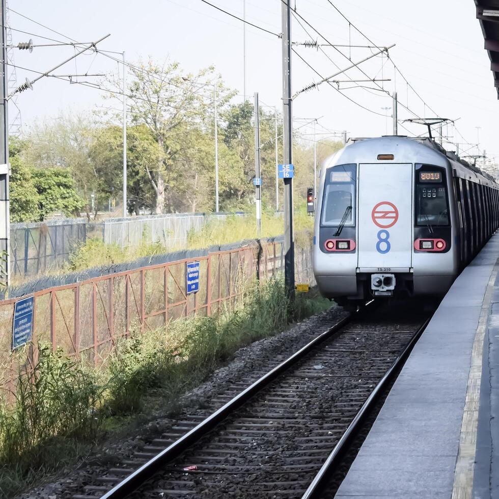 New Delhi, India, February 17 2024 - Delhi Metro train arriving at Jhandewalan metro station in New Delhi, India, Asia, Public Metro departing from Jhandewalan station photo