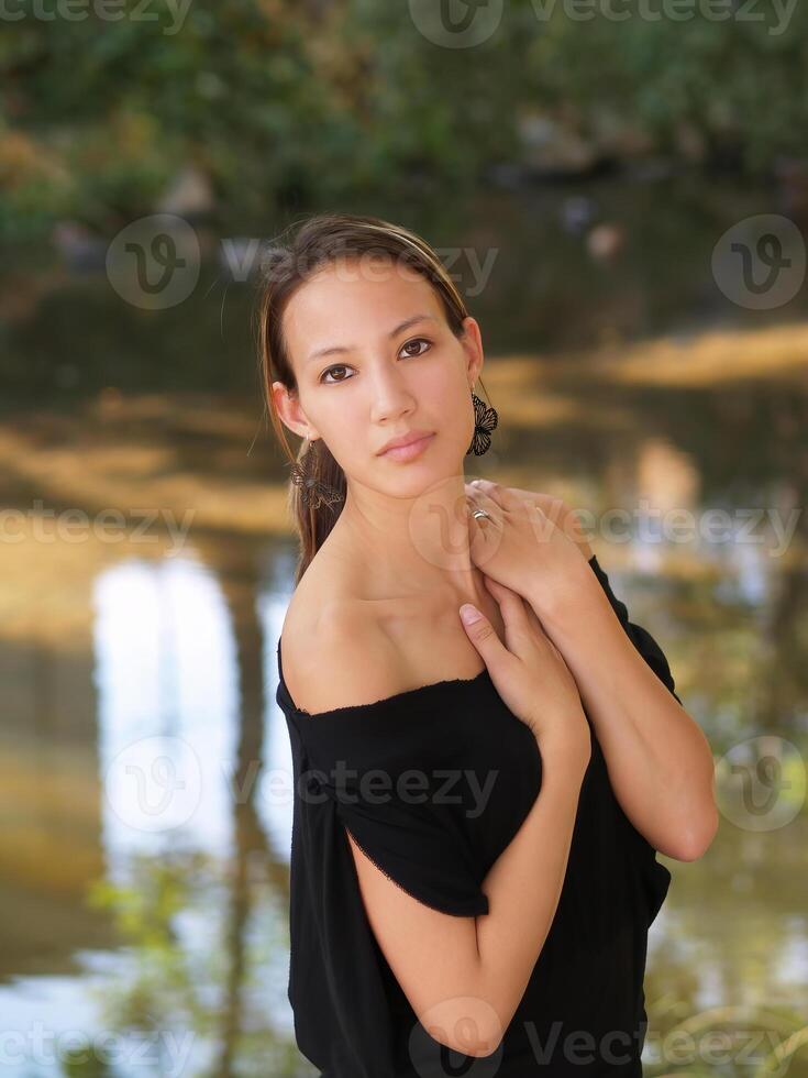 Attractive Asian American Woman In Black Top Outdoors photo