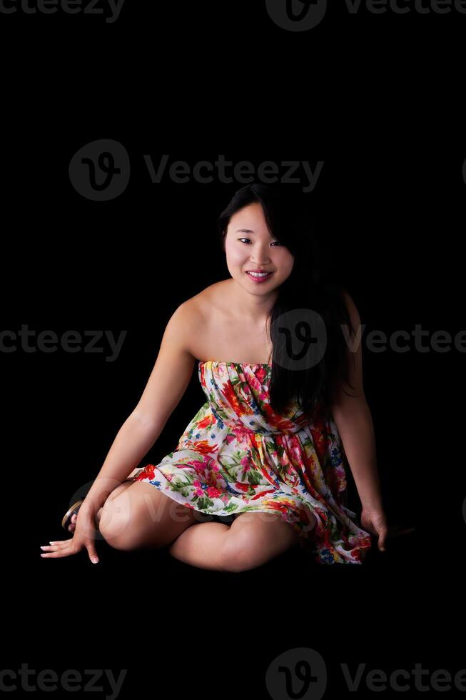 Young Japanese American Woman Sitting In Floral Dress photo