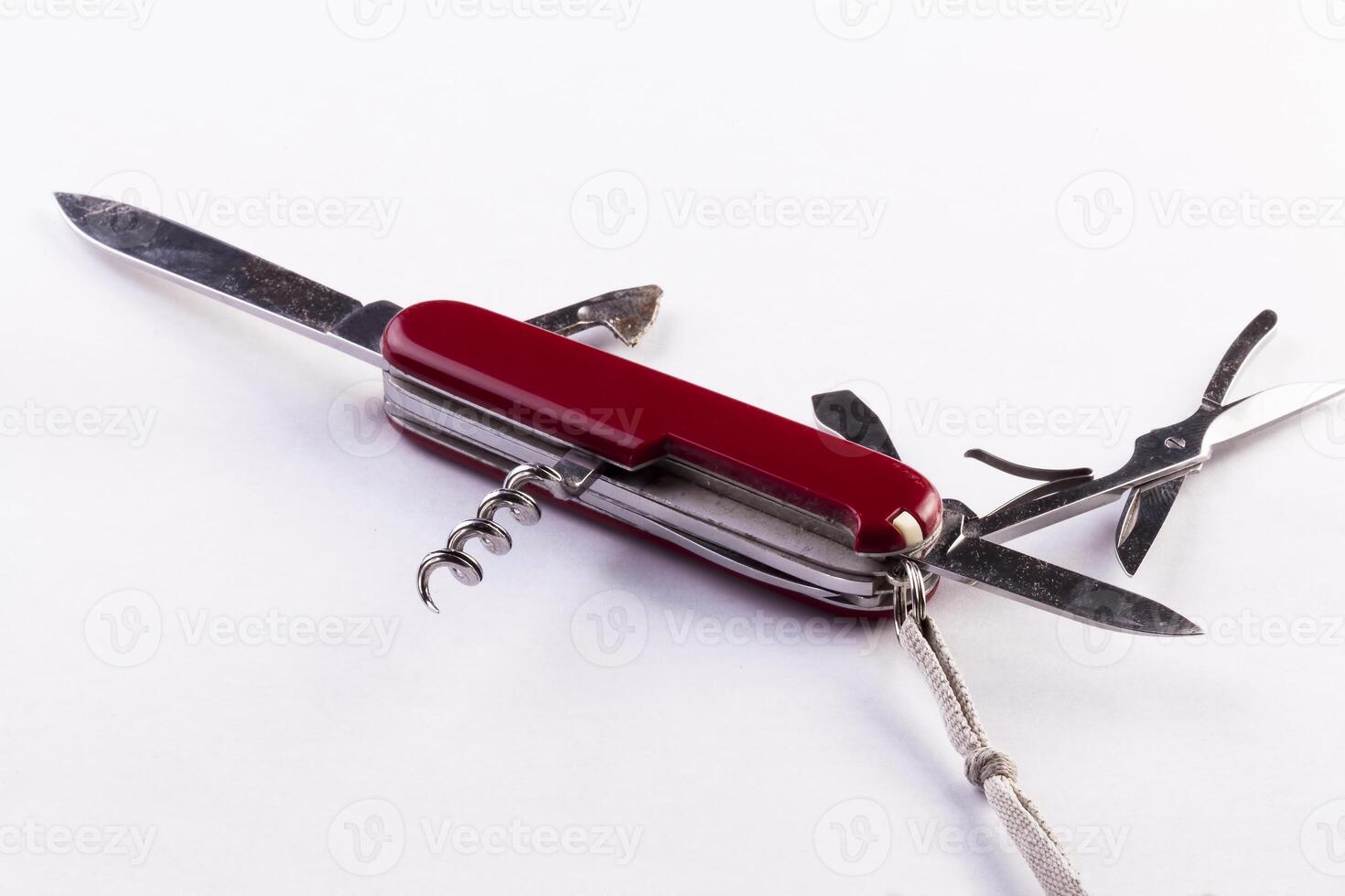 Old Red Multi-Function Pocket Knife Opened On White Background photo