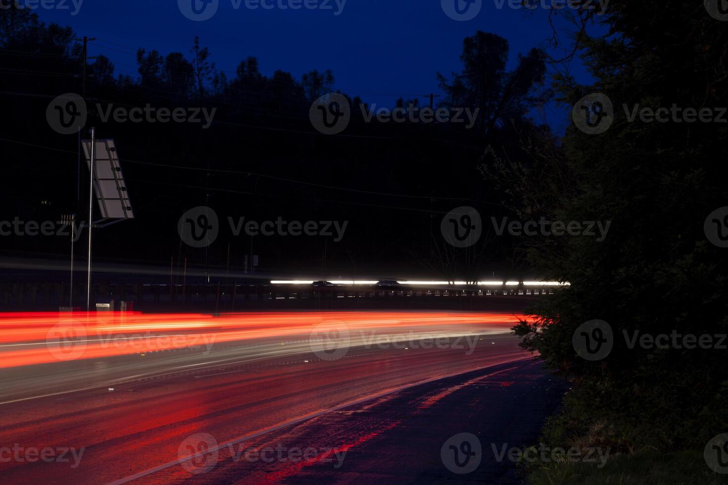 Red Tail Light Trails On Curve Road Night photo