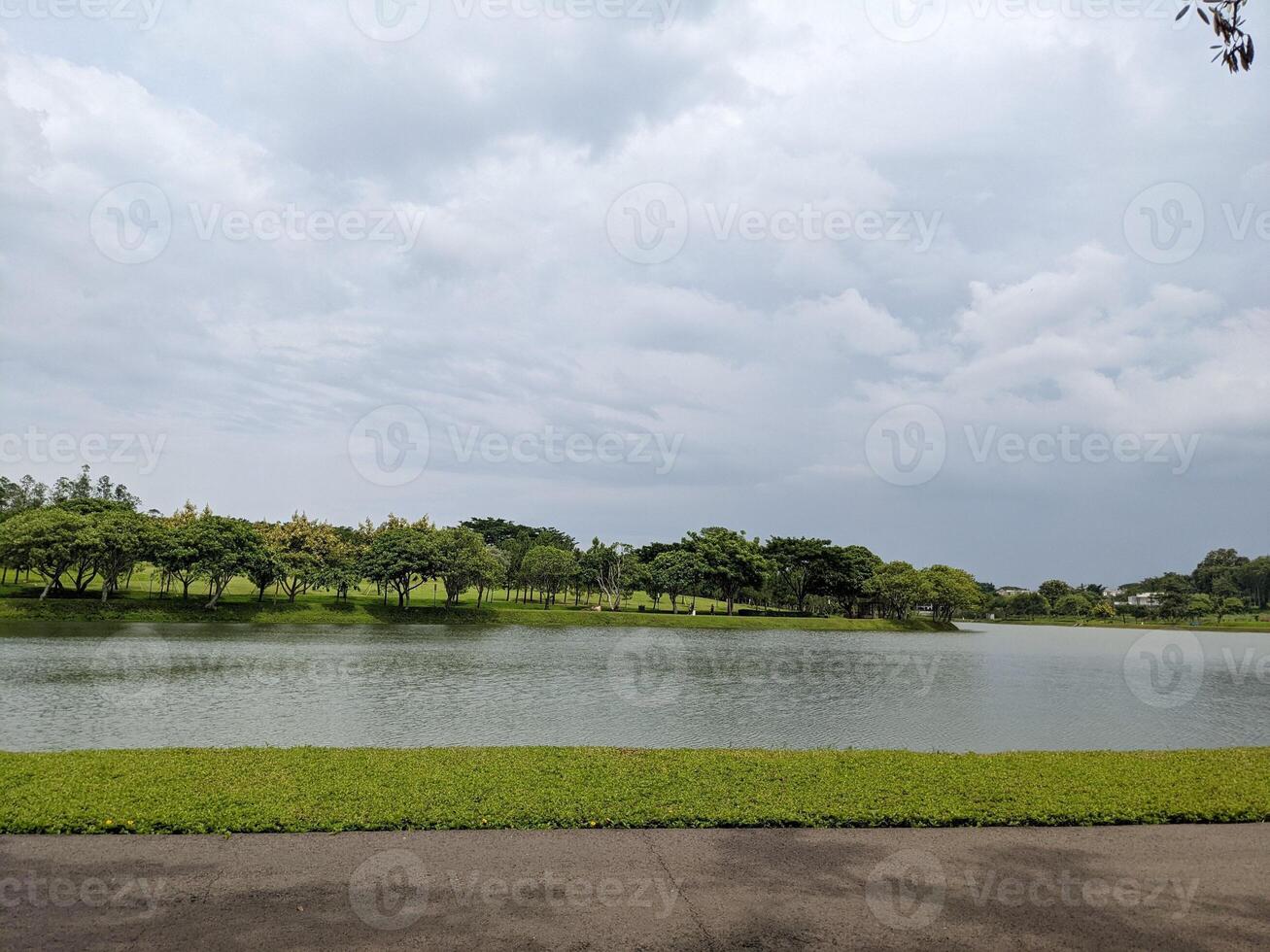 Landscape lake, track and wooden dock on BSB Semarang, Central Java. The photo is suitable to use for traveler content media, holiday background and garden poster.