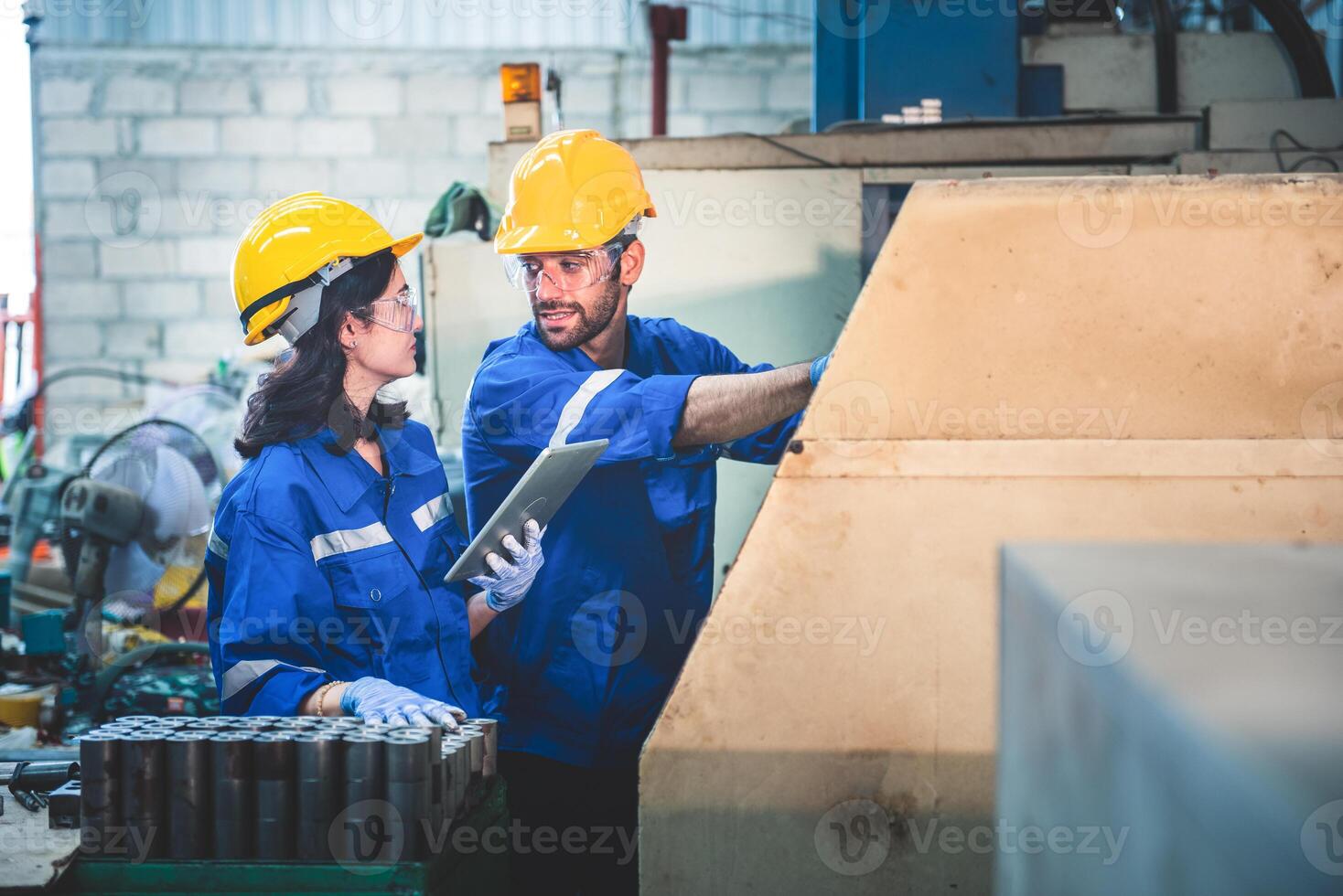 Portrait of Heavy industry workers working on the metal fabrication process by operating a lathe at a machine for steel structure industry. photo