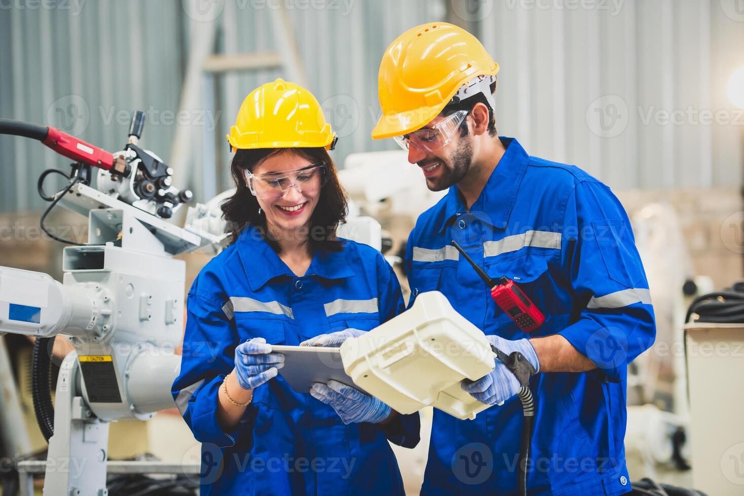 Engineers team mechanic using computer controller Robotic arm for welding steel in steel factory workshop. Industry robot programming software for automated manufacturing technology photo