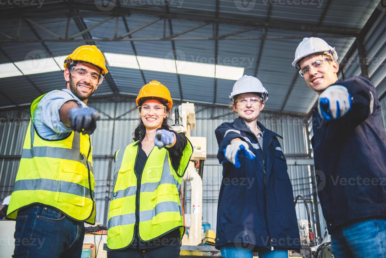 Engineers team mechanic standing in steel factory workshop. Industry robot programming software for automated manufacturing technology photo