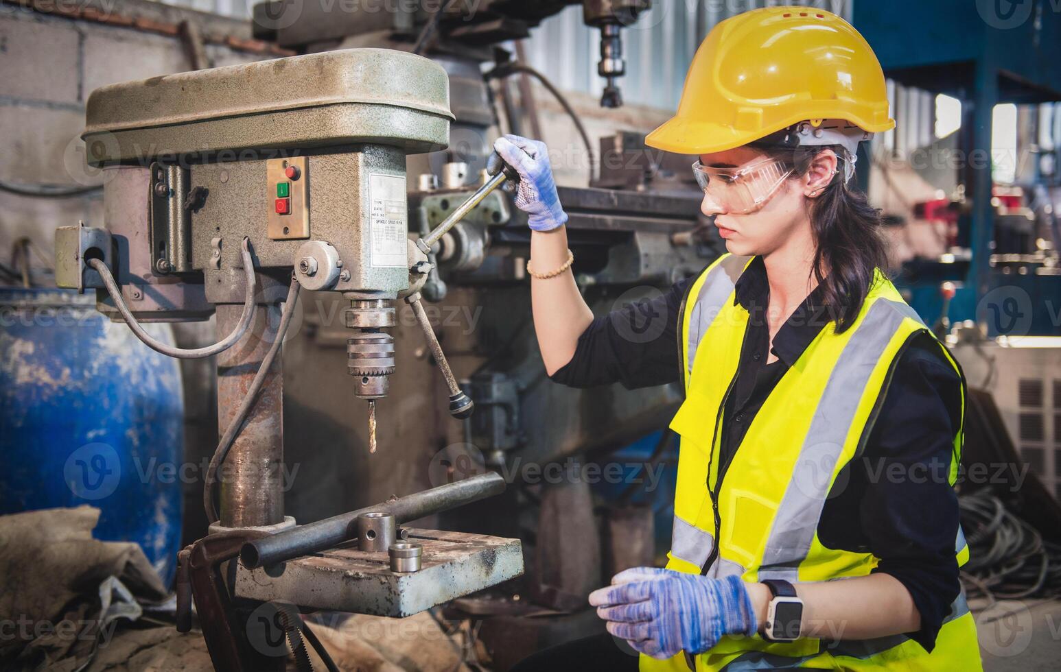 Portrait of Heavy industry workers working on the metal fabrication process by operating a drilling at a machine for steel structure industry. photo