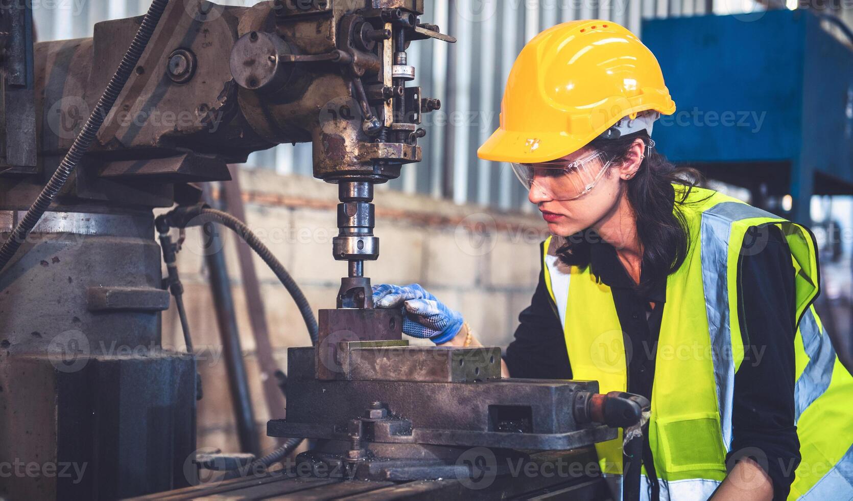 Portrait of Heavy industry workers working on the metal fabrication process by operating a lathe at a machine for steel structure industry. photo