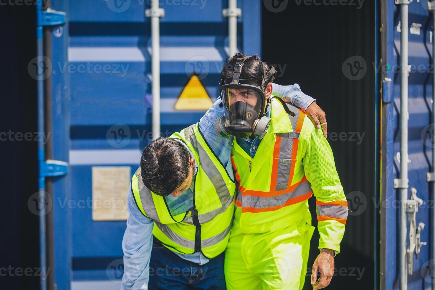 Engineer wear PPE urgently assisted the male technique inside container as Chemical spill in the container shipping industry photo