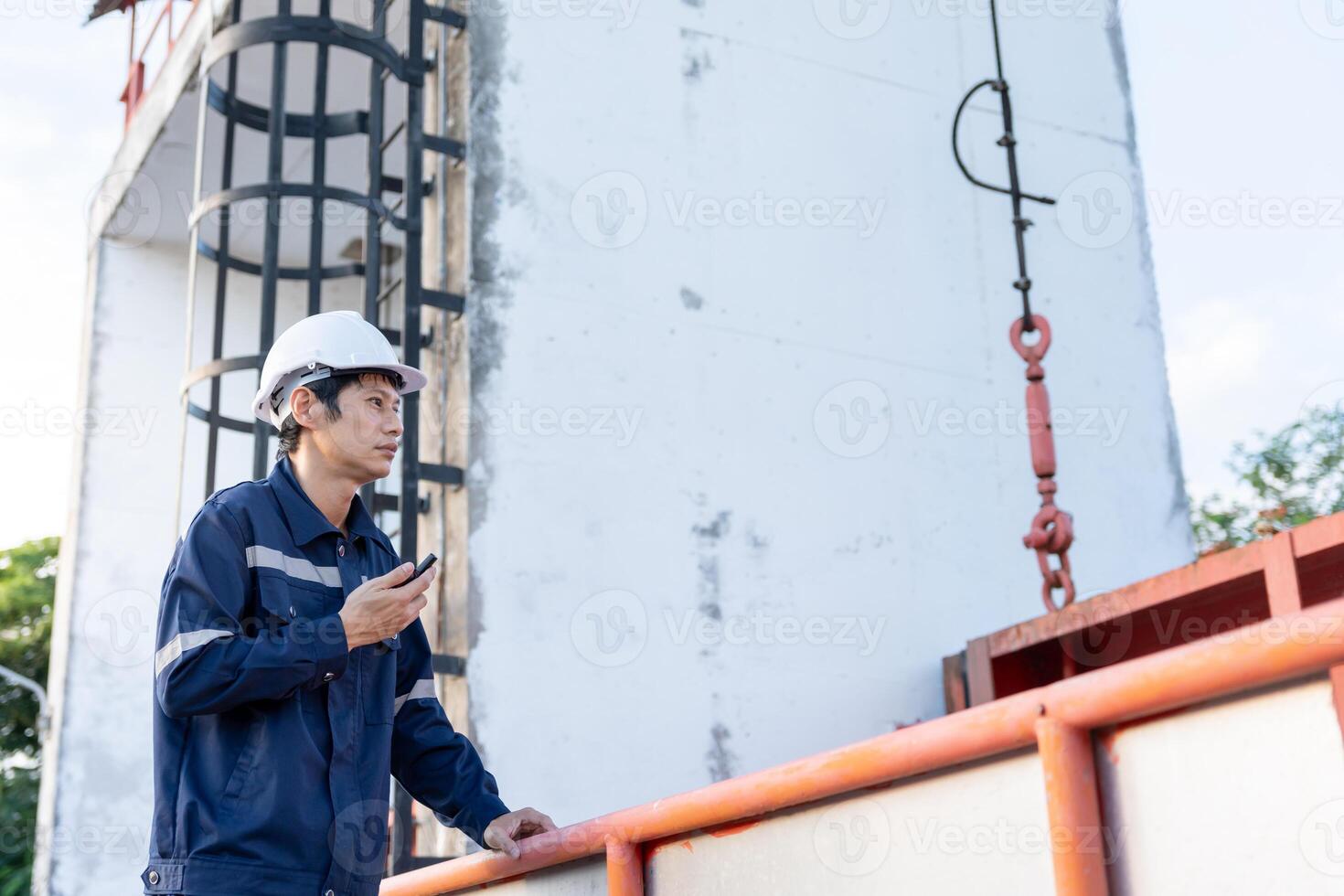 maintenance and inspector. Maintenance engineers are using walky talky to inform the results of inspection of buildings and structures. Irrigation engineers are exploring sluice systems photo