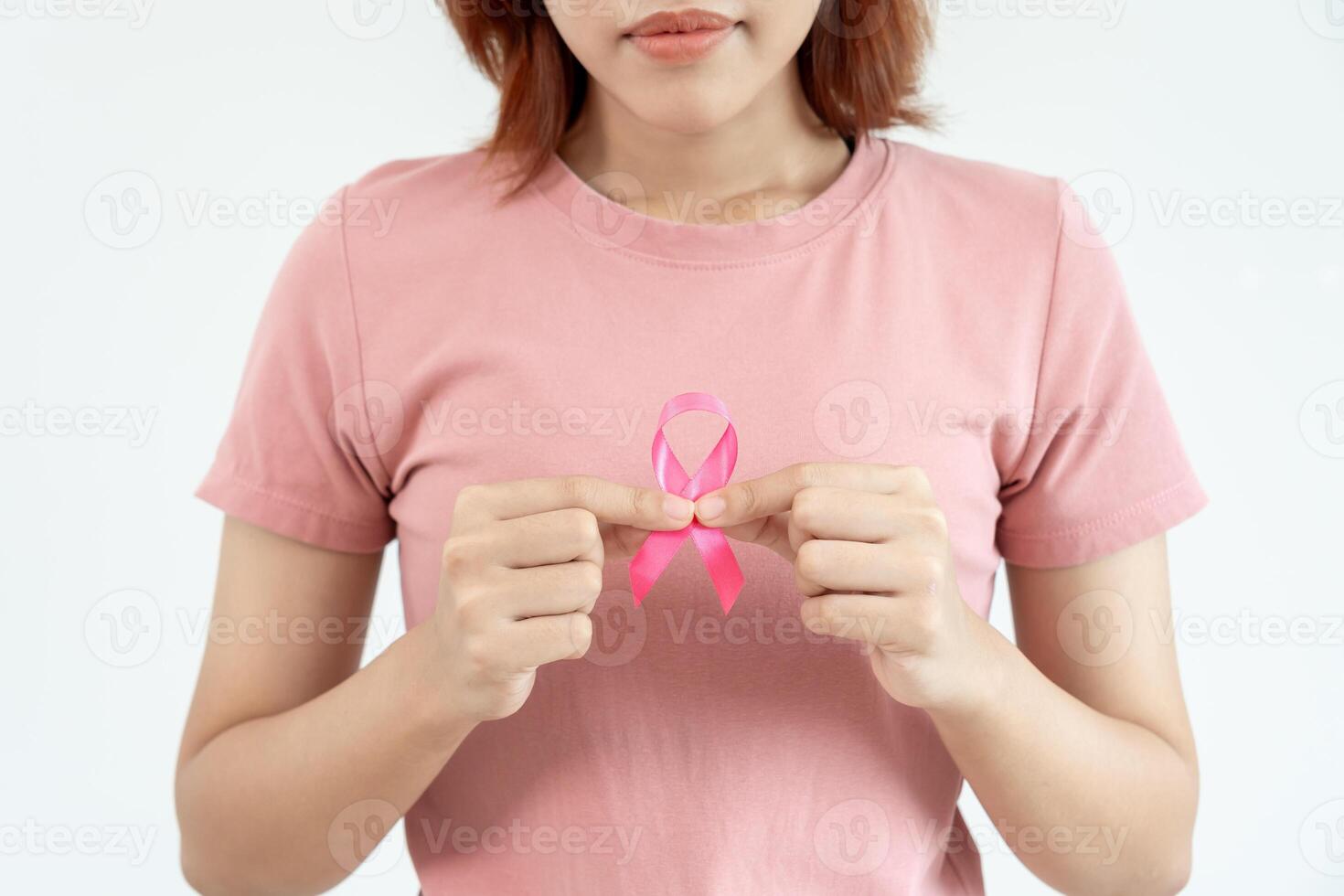 Woman hold pink ribbon breast cancer awareness. Female health check consciousness. international Women Day and World Cancer Day. sign cancer, Symbolic, health care, support patients, timely diagnosis photo