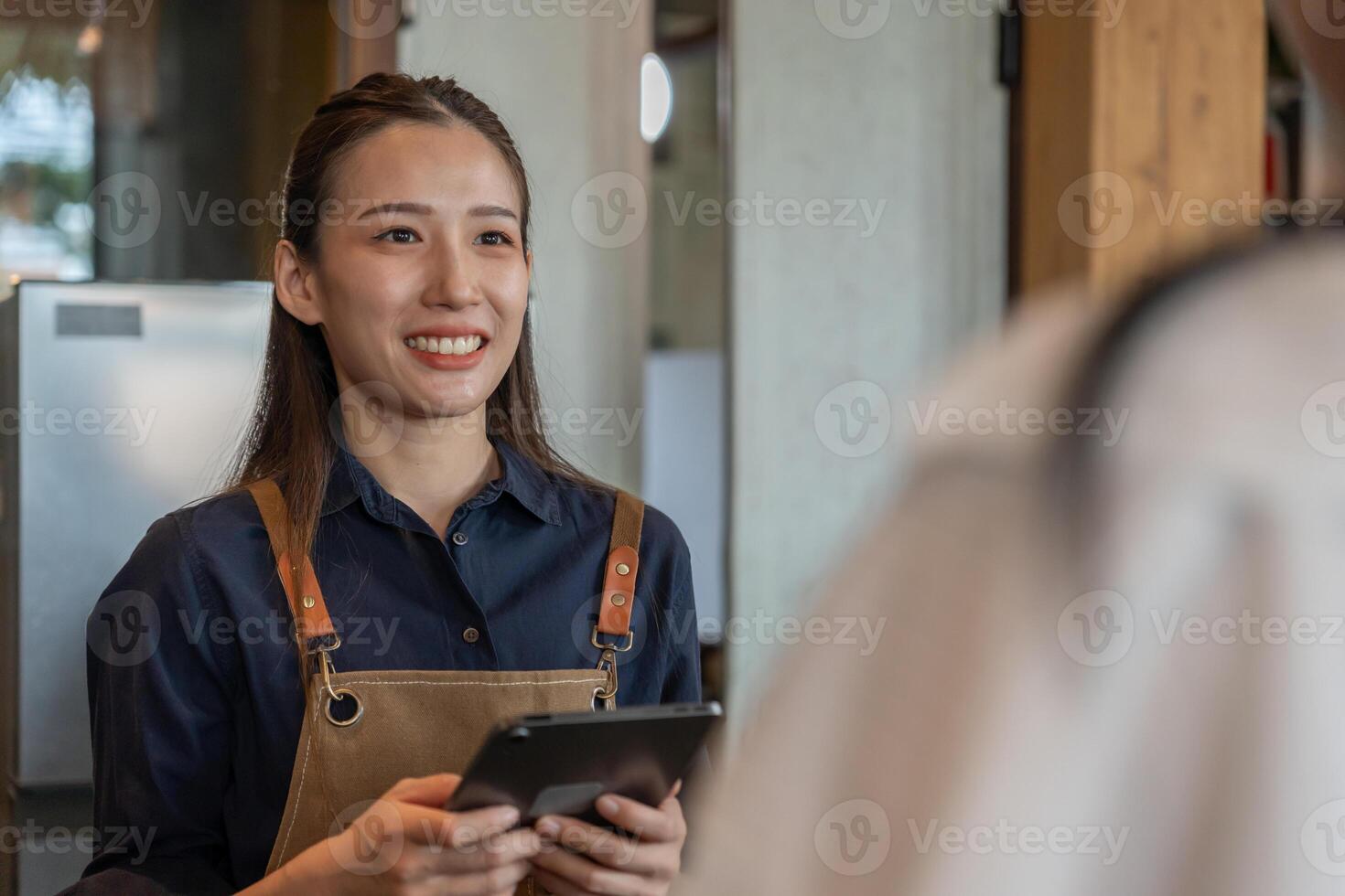 Asia woman owner happy and smile receive order from customer. guarantees safety, cleanliness, open the coffee shop. open for New normal. Small business, welcome, restaurant, home made, cafe photo