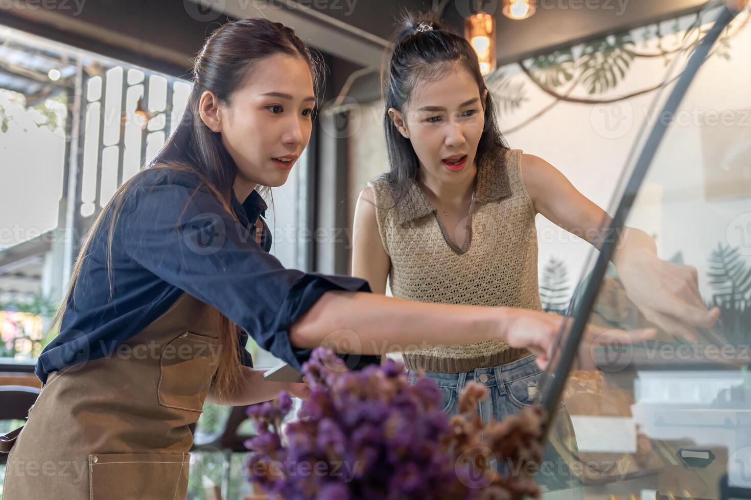 Asia woman owner happy and smile receive order from customer. guarantees safety, cleanliness, open the coffee shop. open for New normal. Small business, welcome, restaurant, home made, photo