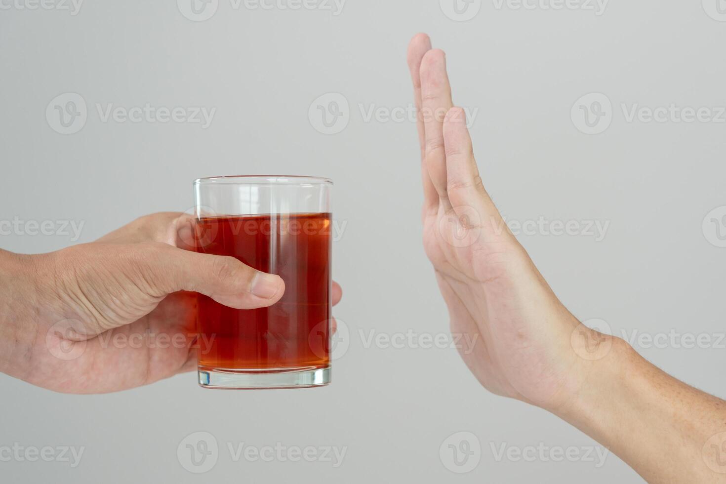 refuses say no and avoid to drink an alcohol whiskey , stopping hand sign male, alcoholism treatment, alcohol addiction, quit booze, Stop Drinking Alcohol. Refuse Glass liquor, unhealthy, reject photo