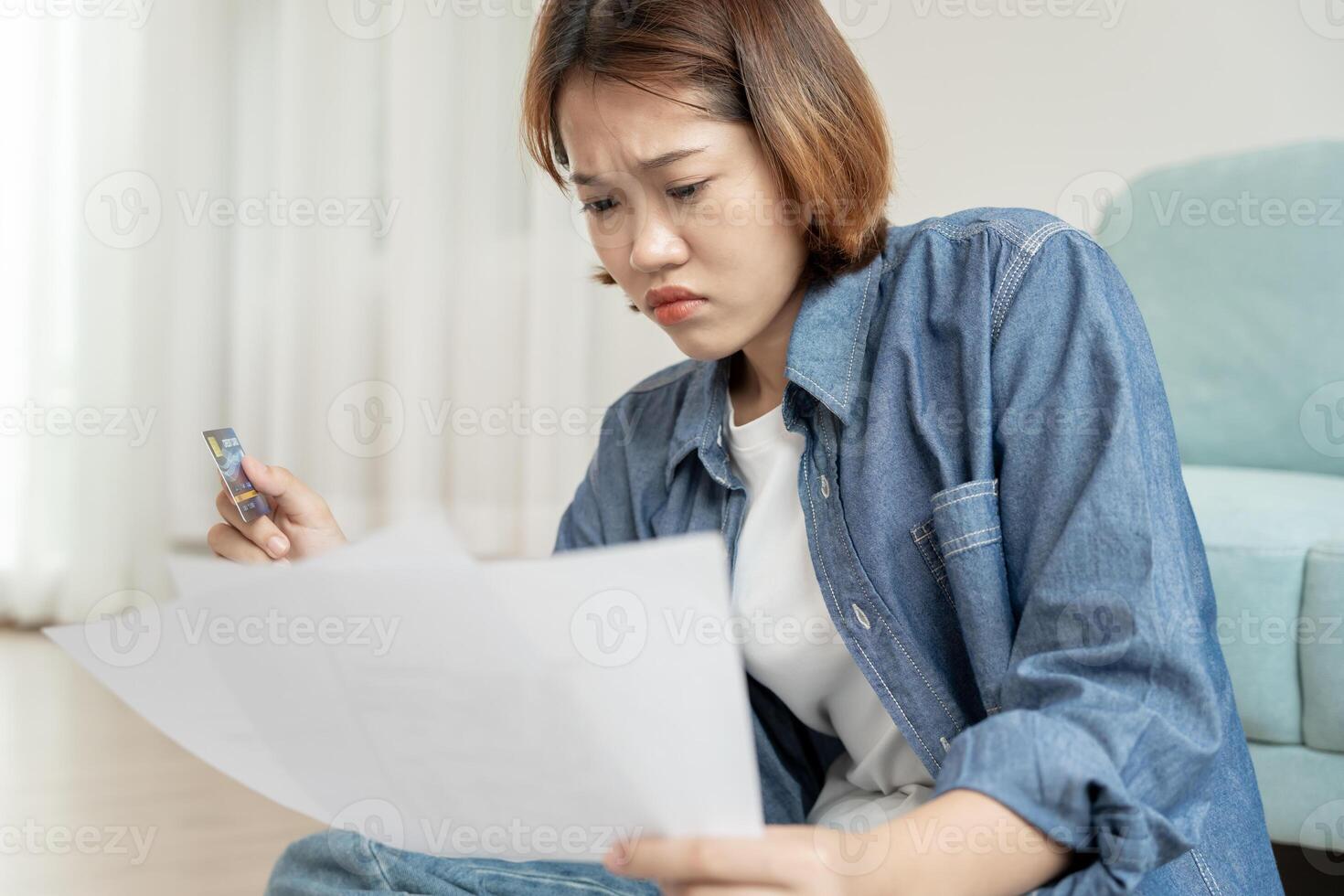 Stressed and headache asian woman with large bills or invoices no money to pay to expenses and credit card debt. shortage, Financial problems, mortgage, loan, bankruptcy, bankrupt, poor, empty wallet photo