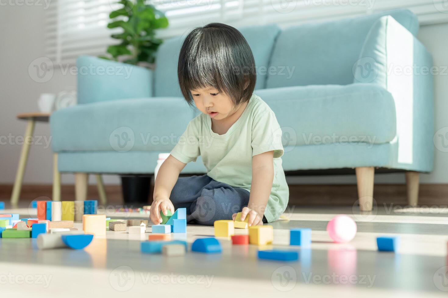 Happy Asian child playing and learning toy blocks. children are very happy and excited at home. child have a great time playing, activities, development, attention deficit hyperactivity disorder photo