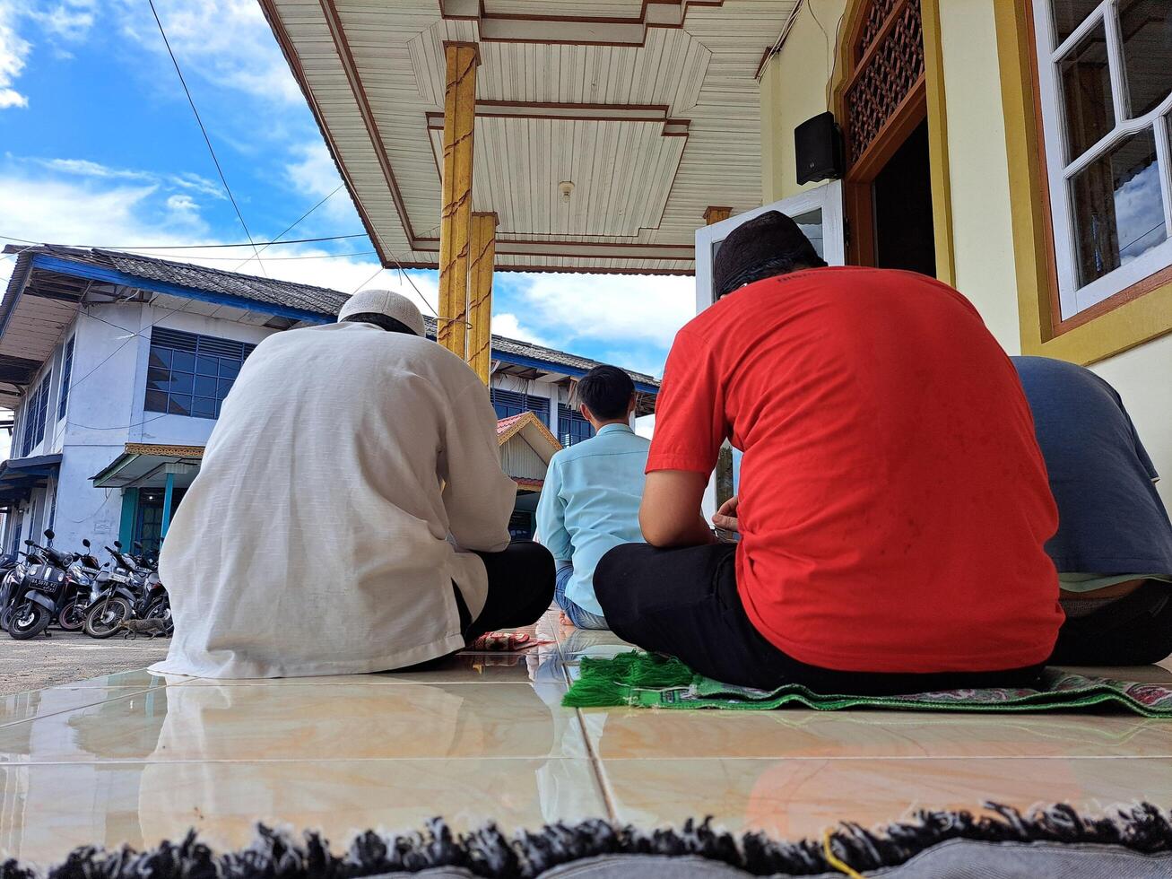 tapin, indonesia - january 12th 2024 sitting person photographed from behind in the photo with a low angle