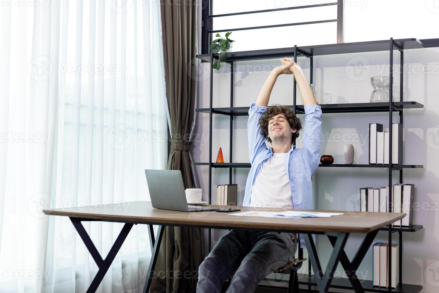 Caucasian man freelancer is having relieve with his successful job while working at home  about online task for accountant, auditor, programer and broker occupation photo