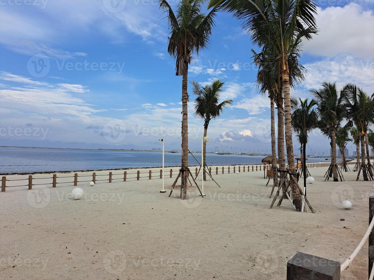 Jakarta, Indonesia - January 30th 2024 Pantai Indah Kapuk Aloha atmosphere with white sand, sea and blue sky photo