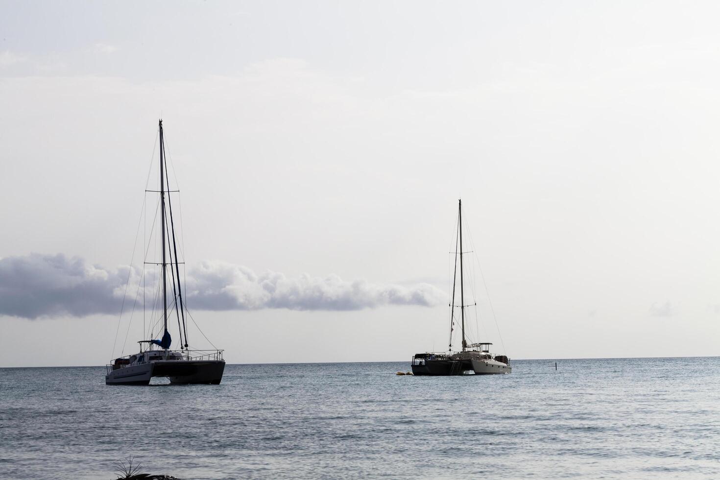 Kona, HI, 2011 - Two Catamaran Sailboats At Anchor photo