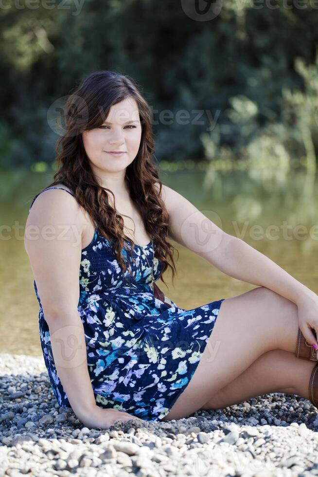 Young Plump Caucasian Woman Outdoors Dress Sitting photo