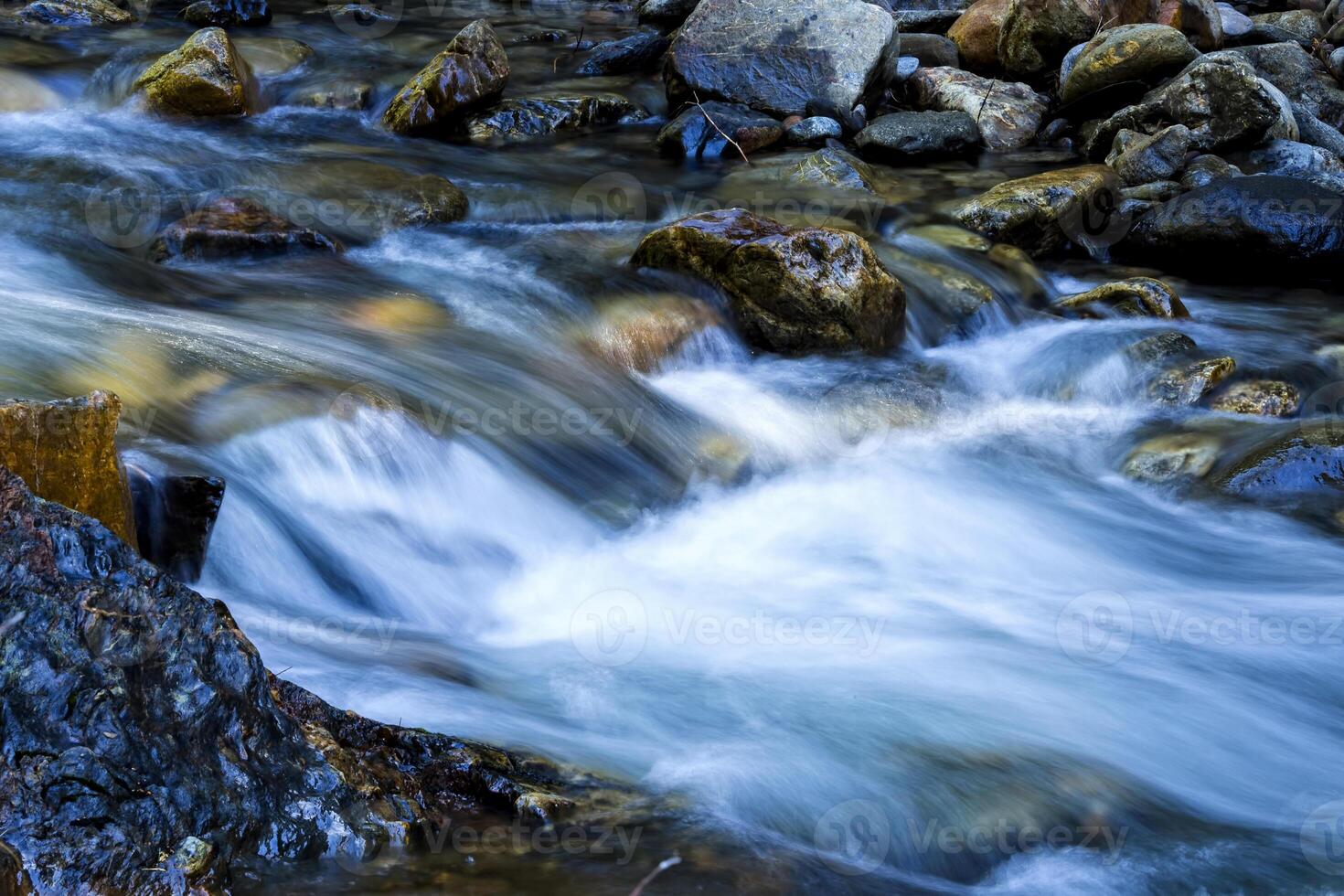 Long Exposure Small Stream Flowing Over Rocks photo