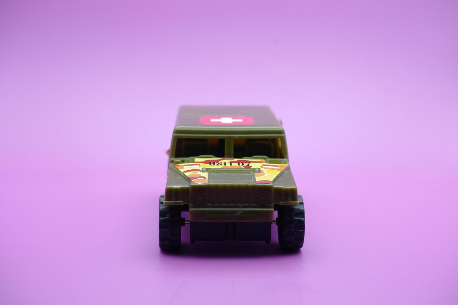 toy car isolated on purple background. imitation of an ambulance usually used by the armed forces. photo