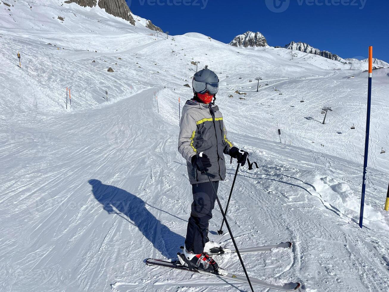 a person on skis on a snowy slope photo